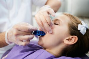 dentist taking an impression of a patient's teeth
